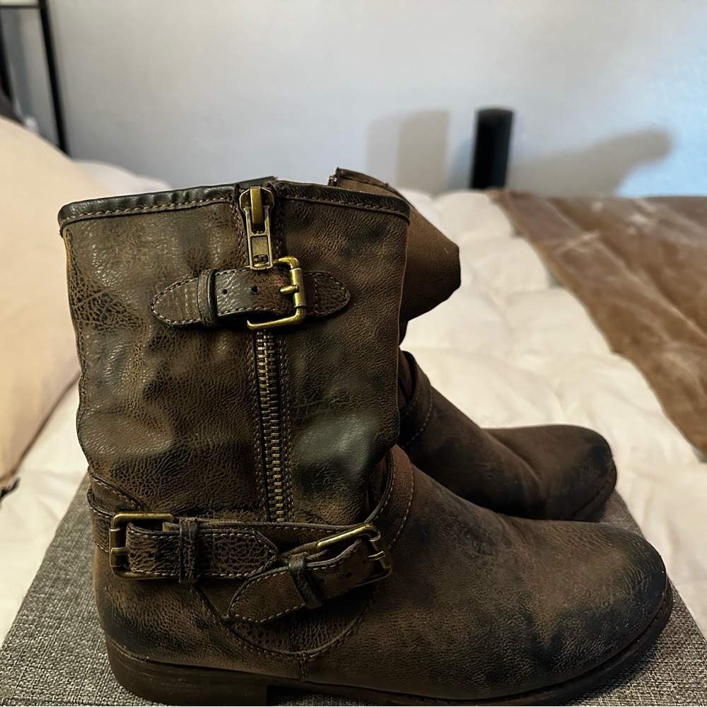 Brown buckle boots with a slight heel.
